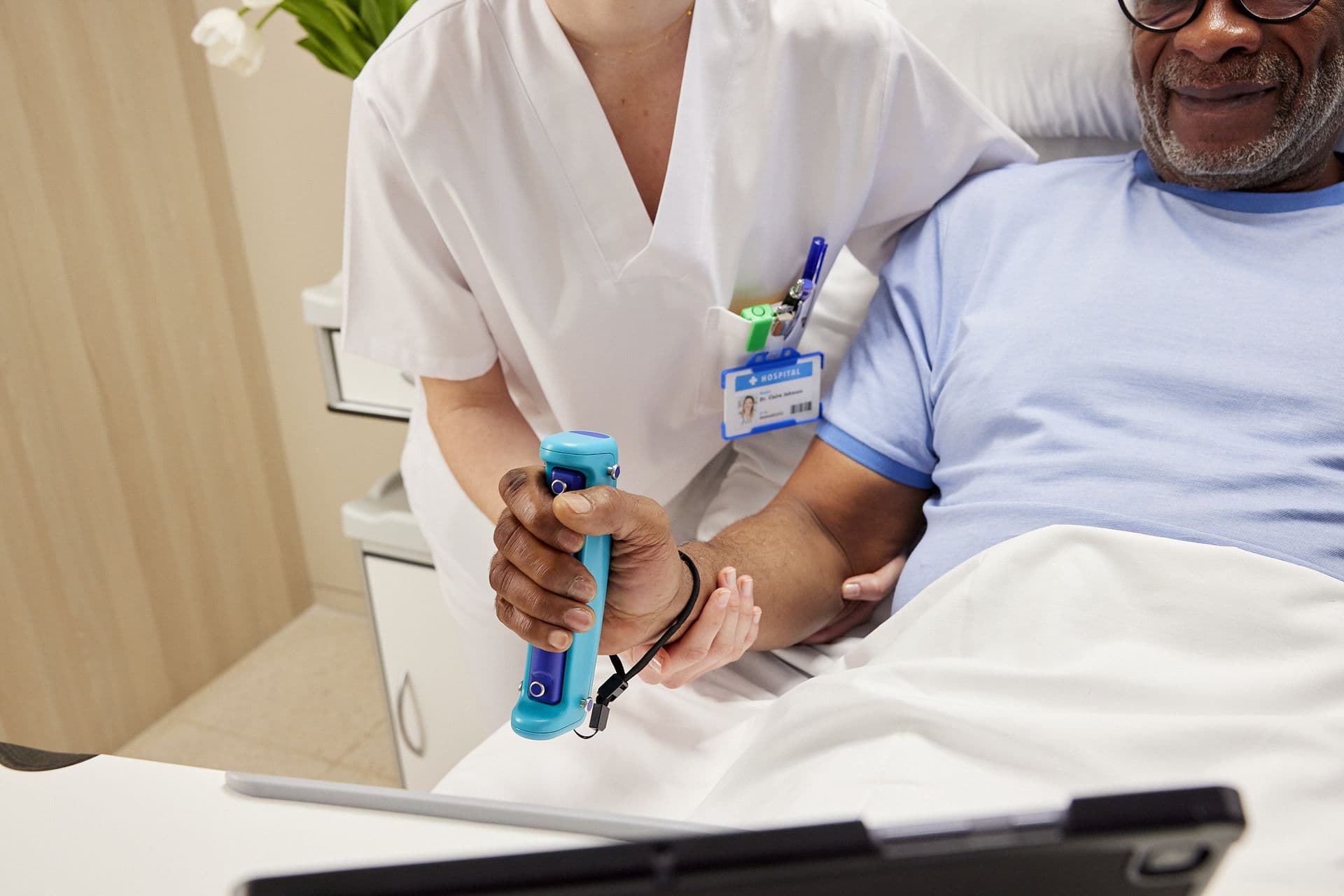 Hands fitting GripAble sensor on patient