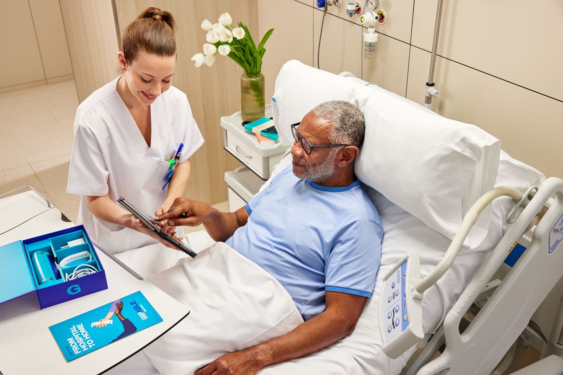 Therapist assessing a patient at their bedside