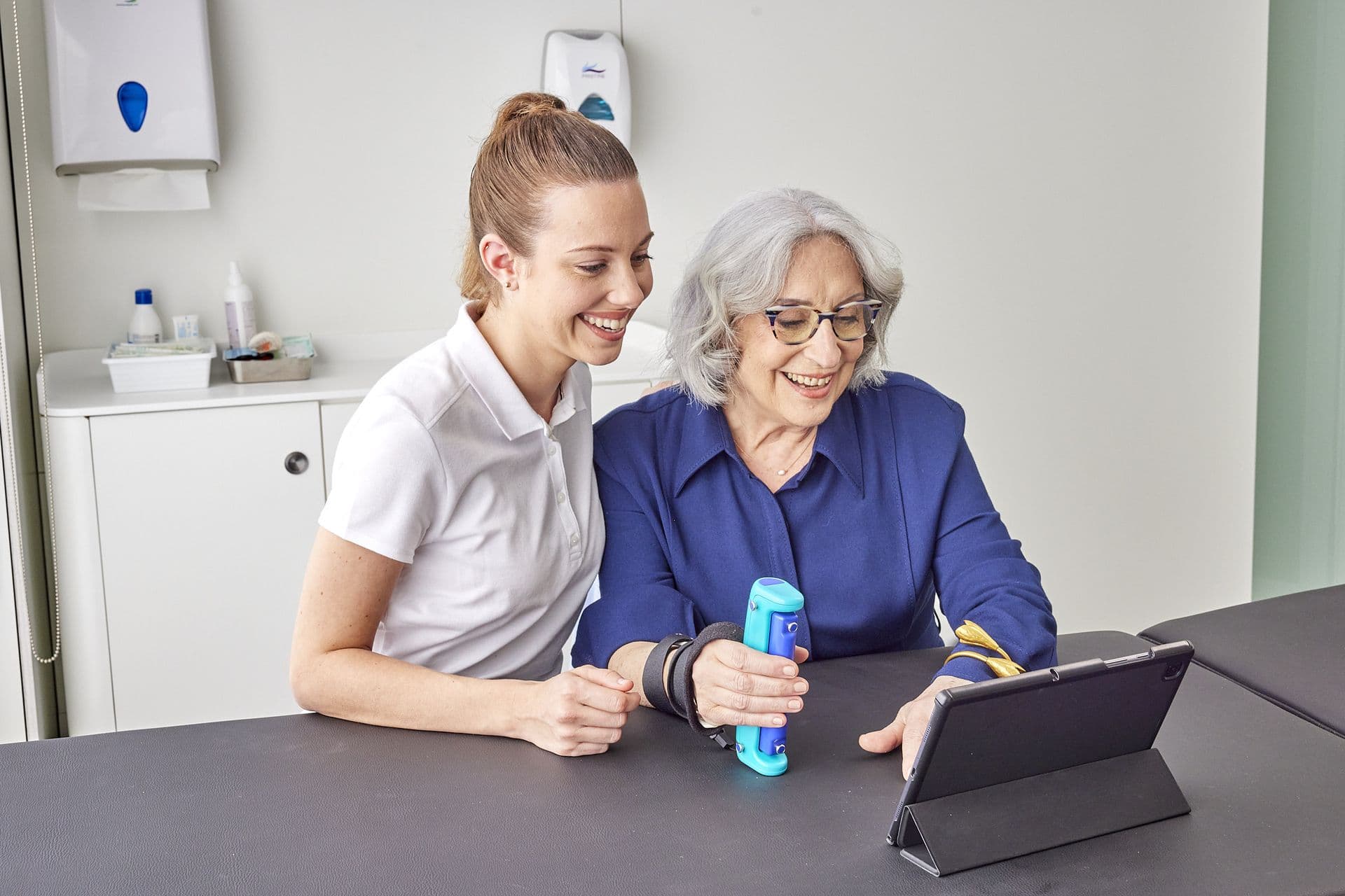 Therapist reviewing Able Assess results with a patient on a tablet