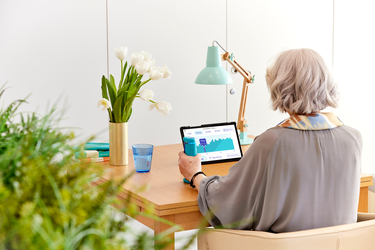 woman sitting looking at tablet screen, grip strength and metabolic diseases